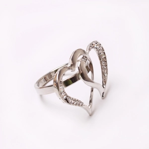 Detail view of interlocking heart napkin ring with sparkling crystals and silver finish