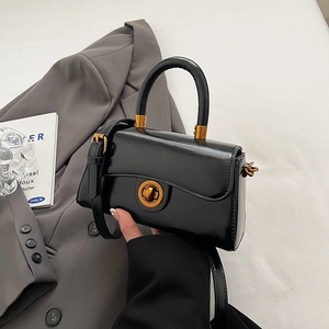 Elegant black glossy small square handbag with golden round lock and curved edge design