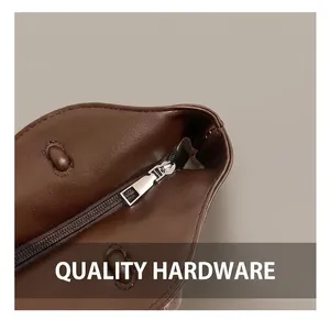 Close-up of high-quality silver metal zipper and smooth dark brown leather tote bag