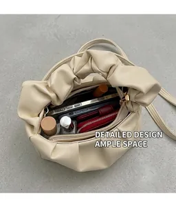 Spacious interior of beige pleated cloud bag showing phone, wallet and cosmetics storage