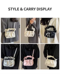 Detailed view of pleated mini handbags with pearl bows in white, black, silver, and pink