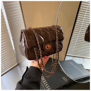 Détail du sac matelassé marron chocolat avec fermoir doré et bandoulière en chaîne