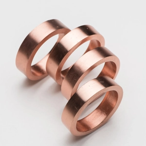 Set of four copper napkin rings with modern brushed finish and minimalist design