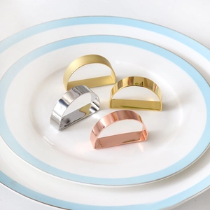 Set of four D-shaped metal napkin rings in gold, silver, and rose gold plating