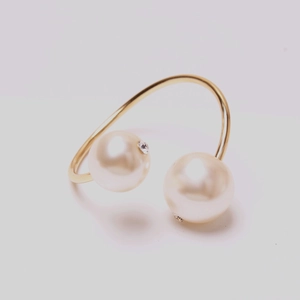 Elegant gold open ring featuring dual white pearls and sparkling rhinestone accents