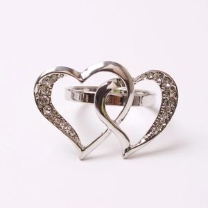 Silver double heart napkin ring with sparkling crystals and polished finish on white base