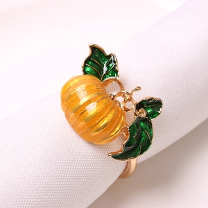 Golden alloy pumpkin napkin ring with orange enamel and green leaf for Halloween decor