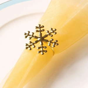 Macro shot of gold snowflake napkin ring showing polished metallic finish and intricate detail