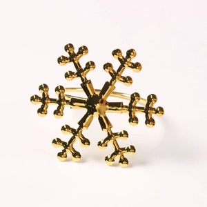 Elegant gold snowflake napkin ring made of polished metal for Christmas table decoration