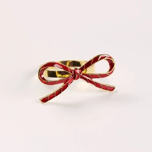 Golden alloy butterfly napkin ring with red enamel bow and gold plaid pattern details