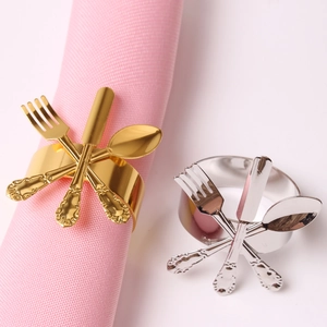 Elegant gold and silver napkin rings featuring cutlery design for festive table settings