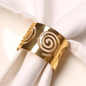 Detailed view of polished gold metal napkin ring with creative hollow spiral design