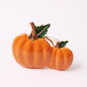 Golden Halloween pumpkin napkin ring with bright orange and green enamel finish