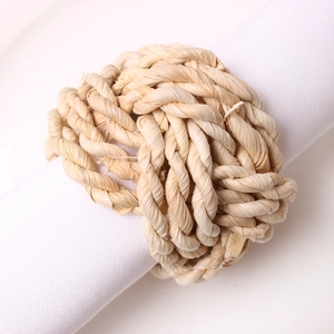 Detailed close-up of handmade woven napkin ring featuring natural plant fiber textures
