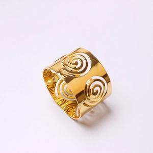 Golden metal hollow swirl napkin rings with elegant cutout spiral pattern for table decor