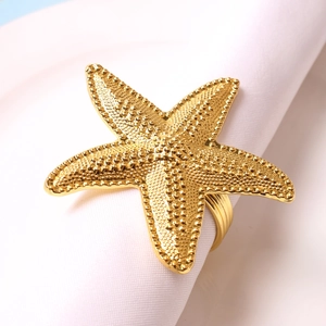 Champagne gold starfish napkin ring with detailed relief texture for elegant table settings