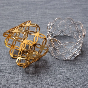 Set of two hollow geometric metal napkin rings in gold and silver finish for table decor