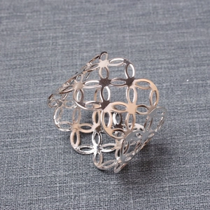 Polished silver metal napkin ring with hollow interlocking circle design for table decor