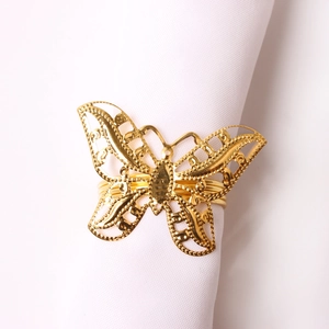 Detailed view of hollow butterfly napkin ring with polished gold-plated finish