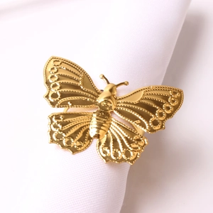 Detailed view of hollow gold butterfly napkin ring showing metallic wing texture