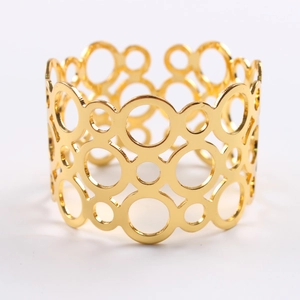 Golden metal napkin ring with hollow geometric circles for elegant table banquet settings