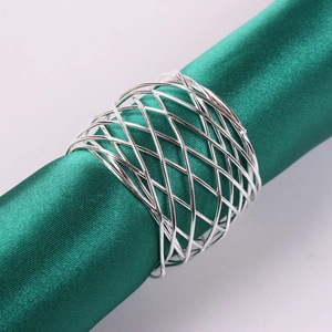 Silver woven mesh metal napkin ring with crisscross wire design on green silk fabric