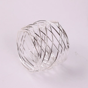 Close-up of woven silver metal napkin ring showing the detailed wire mesh structure