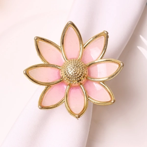 Macro detail of a pink five-petal flower napkin ring with gold frame and pearly finish