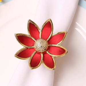 Close-up of red flower napkin ring with gold trim and heart-shaped floral design