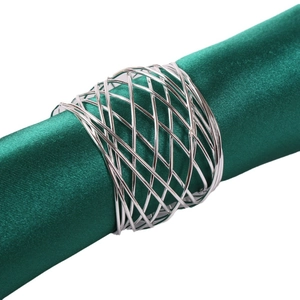 Silver woven metal napkin ring with hollow mesh design on dark green satin cloth