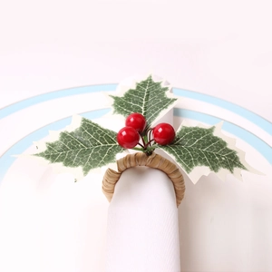 Christmas napkin ring with faux red berries and green leaves on rustic woven base