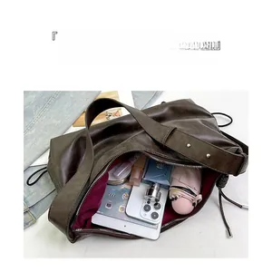 Deep brown leather tote bag interior showing large capacity for tablet and umbrella