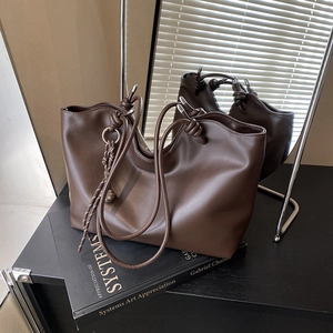 Vintage dark brown large tote bag with knotted shoulder straps and metallic charm detail