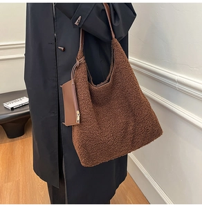 Detail of dark brown faux shearling tote bag with a matching leather coin purse accessory