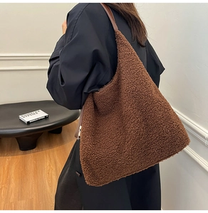 Brown fluffy teddy tote bag styled with a black coat for an elegant winter look