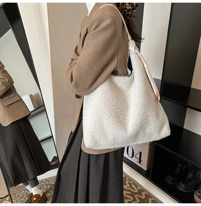 Detail of soft white faux lamb wool tote bag with slim cream leather shoulder straps