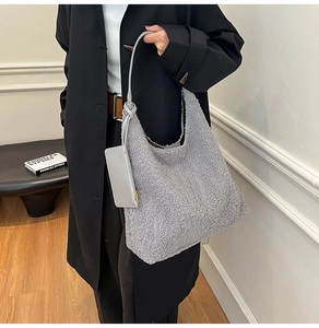 Detail of grey fuzzy lamb wool tote bag with knot strap and small matching pouch