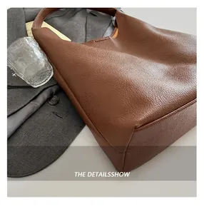 Close-up of the high-quality lychee pattern leather on a large dark brown tote bag