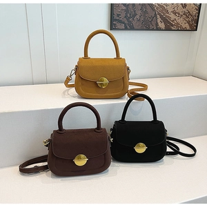 Minimalist saddle bags in mustard, dark coffee, and black on geometric pedestals