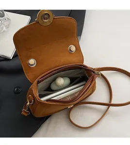 Internal view showing large storage capacity of caramel leather crossbody bag