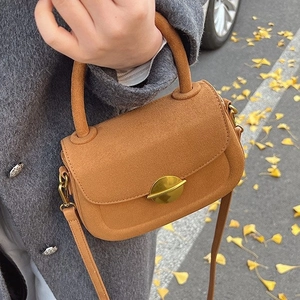 Elegant tan suede mini crossbody bag with golden round buckle for autumn street fashion
