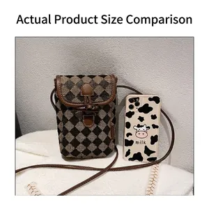 Detailed comparison showing small checkerboard crossbody bag next to a mobile phone