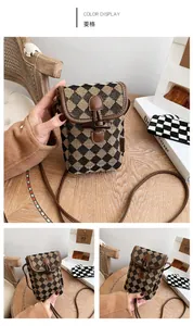 Detail of diamond pattern fabric and wooden toggle closure on crossbody phone bag