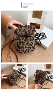 Detail of leopard print mini crossbody bag with vintage wooden toggle and leather trim