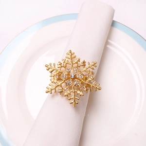 Golden snowflake napkin ring with rhinestones for elegant Christmas table settings