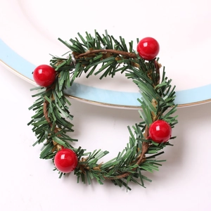 Macro shot of Christmas pine cone napkin ring with festive red berries and green pine needles