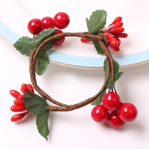 Handmade red berry napkin ring with green leaves for Christmas holiday table setting