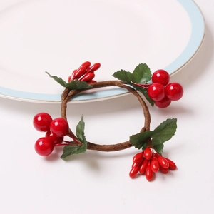 Handmade Christmas napkin ring featuring red berries and green leaves on a vine wreath