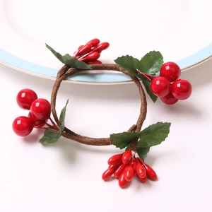 Handmade Christmas napkin ring featuring red berries and green leaves on a woven branch