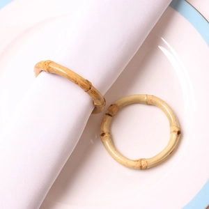 Macro detail showing natural bamboo napkin ring texture and nodes on a white ceramic plate
